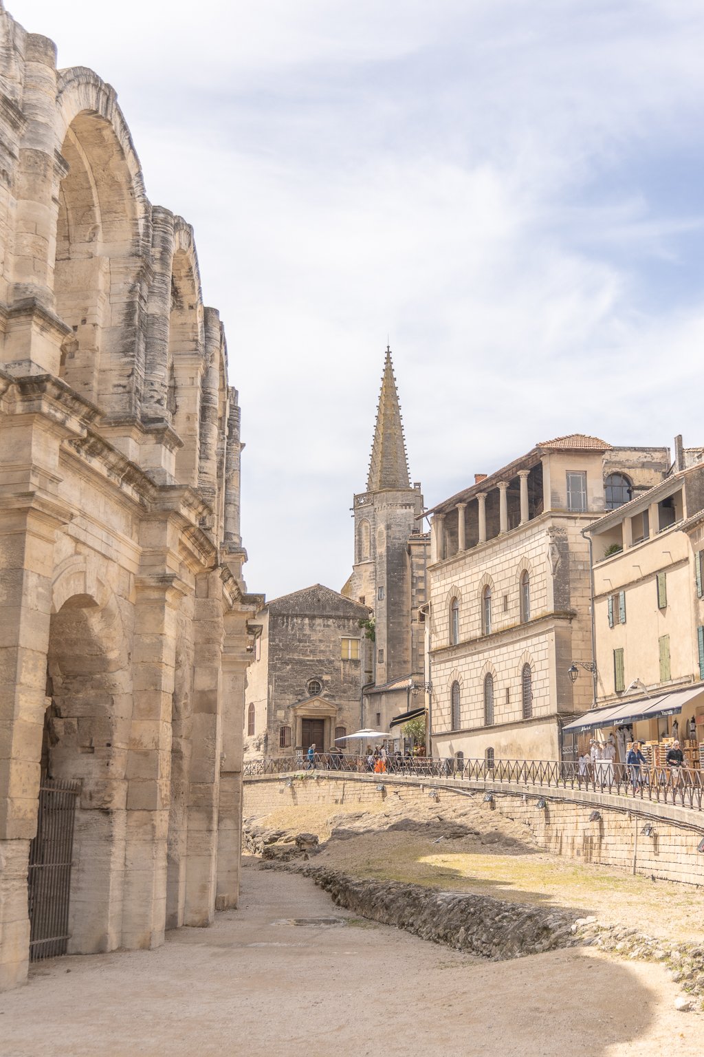 Golden hour light falling on Baroque façades in historic Arles squares