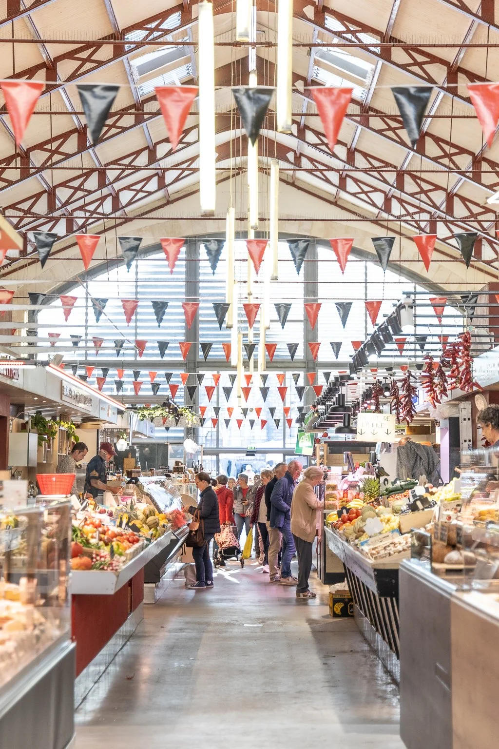 Local Basque products like cheese, sausage, and Espelette pepper at Les Halles Market in Biarritz