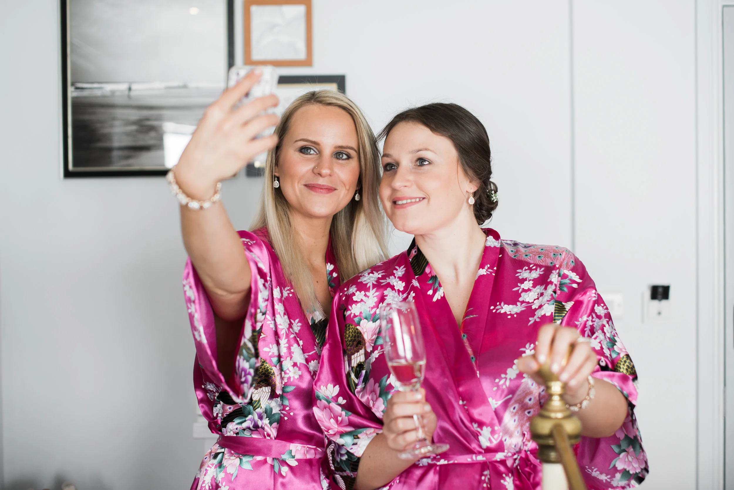 Natural photograph of the bridesmaids taking a selfie as they get ready.