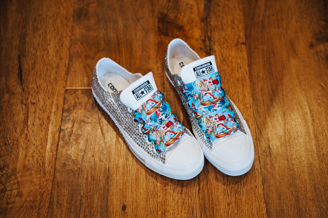 Quirky wedding shoes made by the bride. Converse with bling and Disney themed shoe laces. Lancashire wedding photography