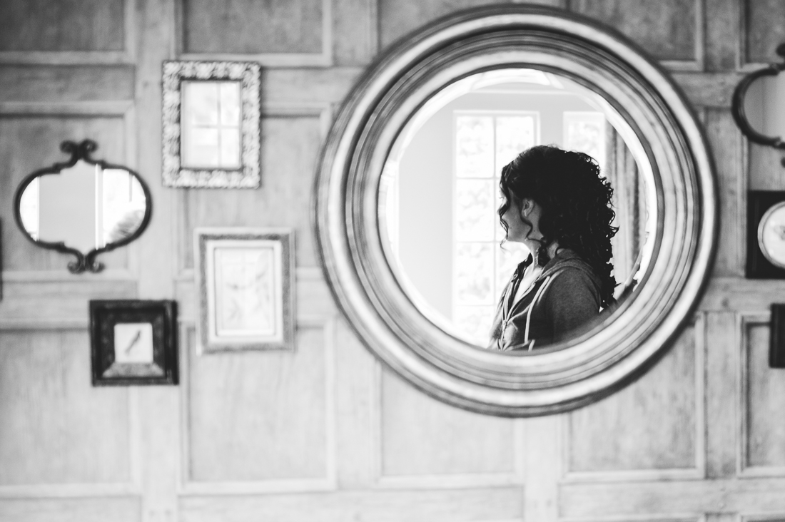 Reflection of the bride in a mirror at Eaves Hall wedding venue. Lancashire wedding photography
