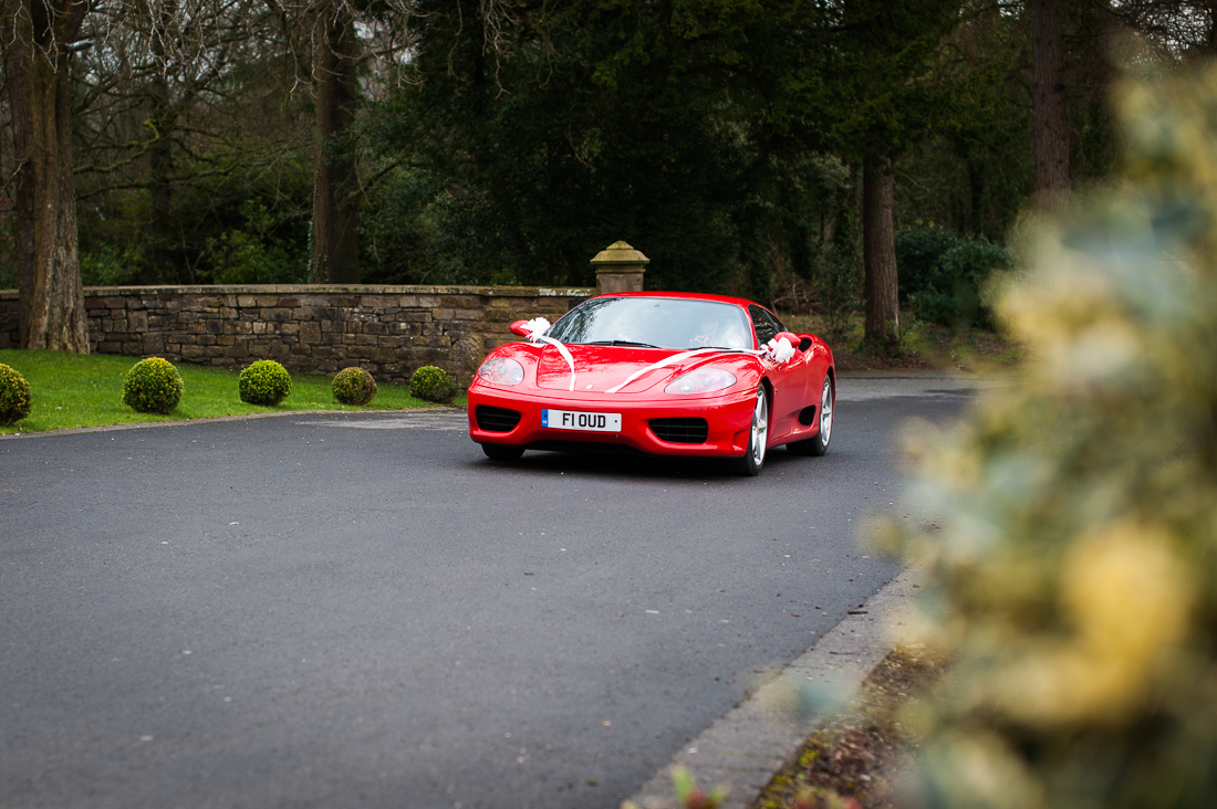 Red Ferrari coming up the drive at Eaves Hall 