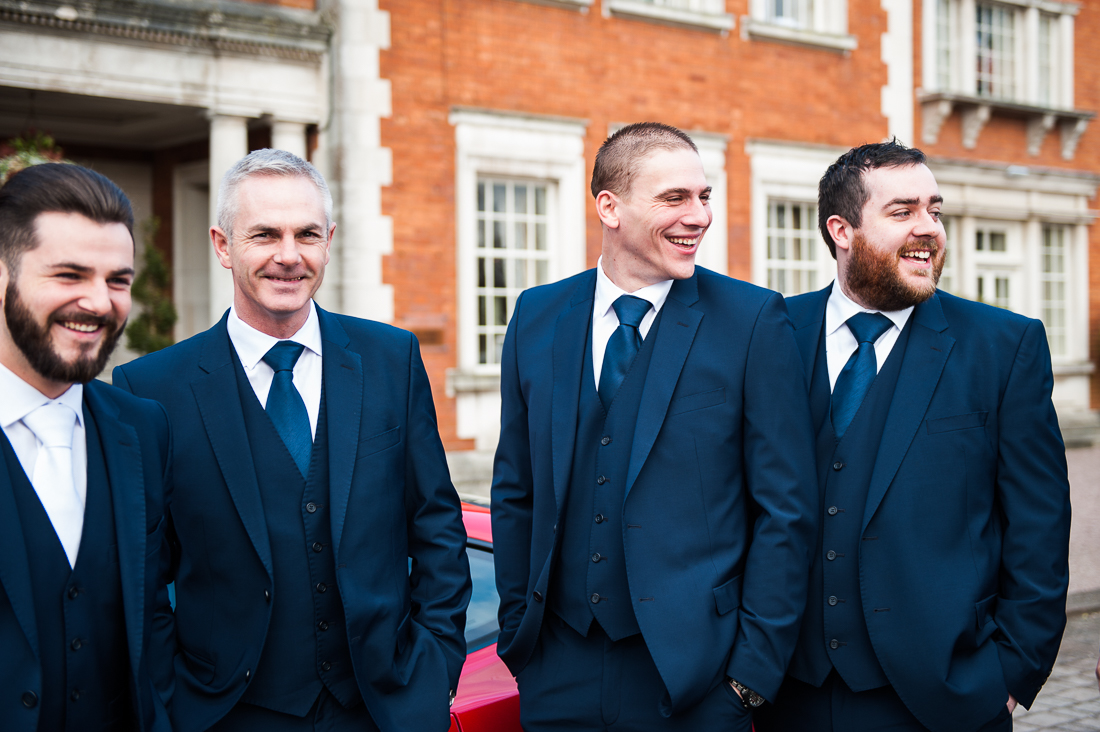 Natural photograph of the groomsmen stood together outside at Eaves Hall, Cliteroe