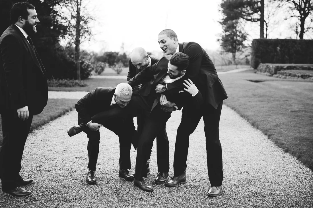 Groomsmen picking up Groom