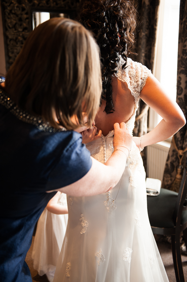 Brides dress being fastened up