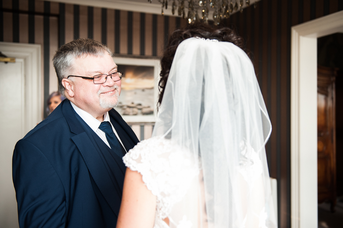 Father of the bride seeing his daughter for the first time on her wedding day. Eaves Hall wedding photography