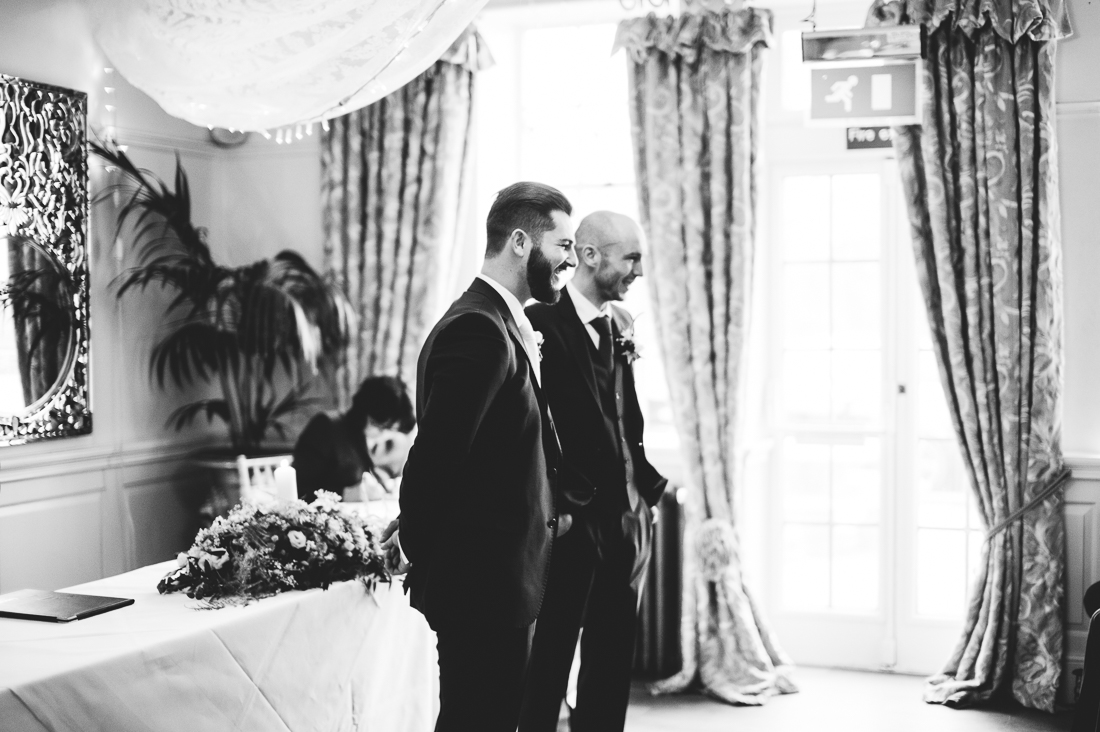 Groom and Best man wait in the isle for the bride to arrive at Eaves Hall wedding