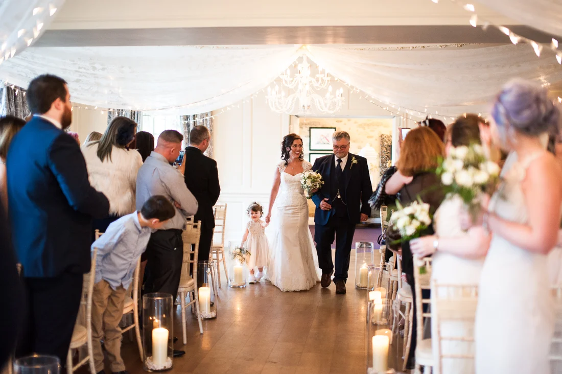 Bride walking down the isle. Eaves Hall wedding photography
