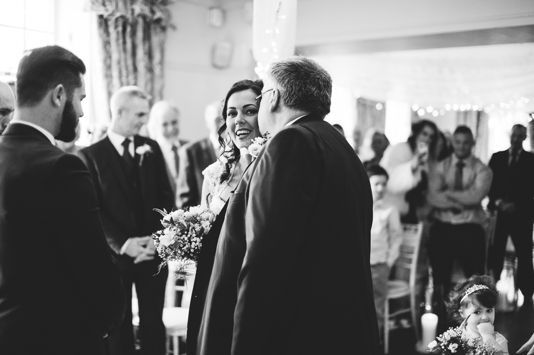 Documentary shot of the father of the bride kissing bride before giving her away