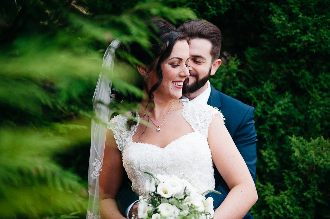 natural shot of the bride and groom laughing together 