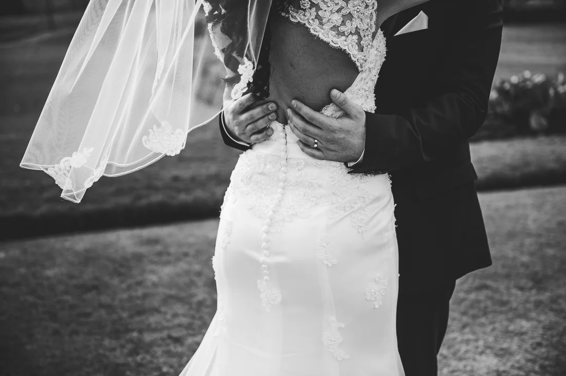 Black and white closeup of the bride and groom in an embrace
