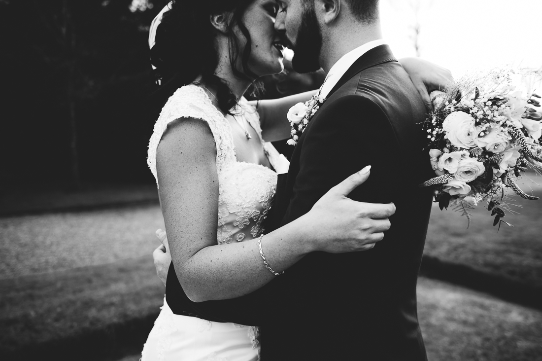 Intimate closeup portrait of the bride and groom kissing