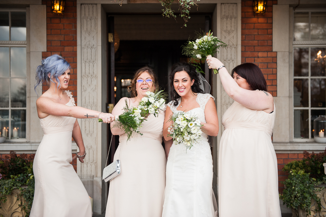 Fun portrait of the bridal party at Eaves Hall