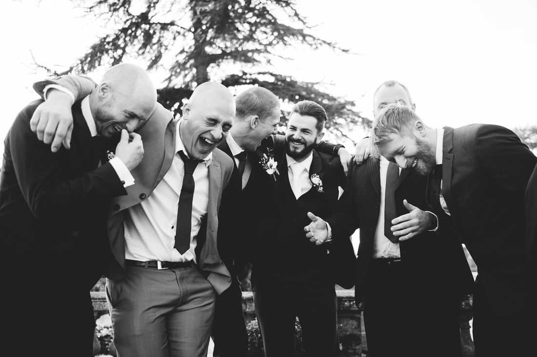 Natural shot of the groomsmen laughing 