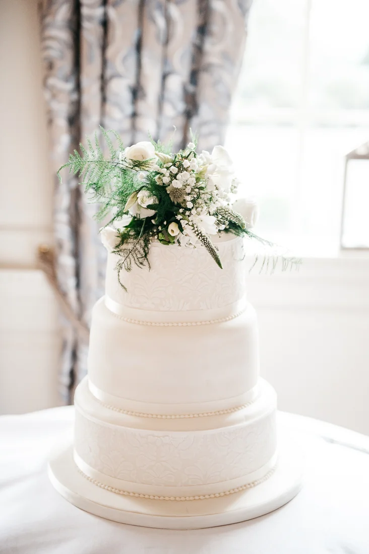 3 tiered cake with real flower topper.