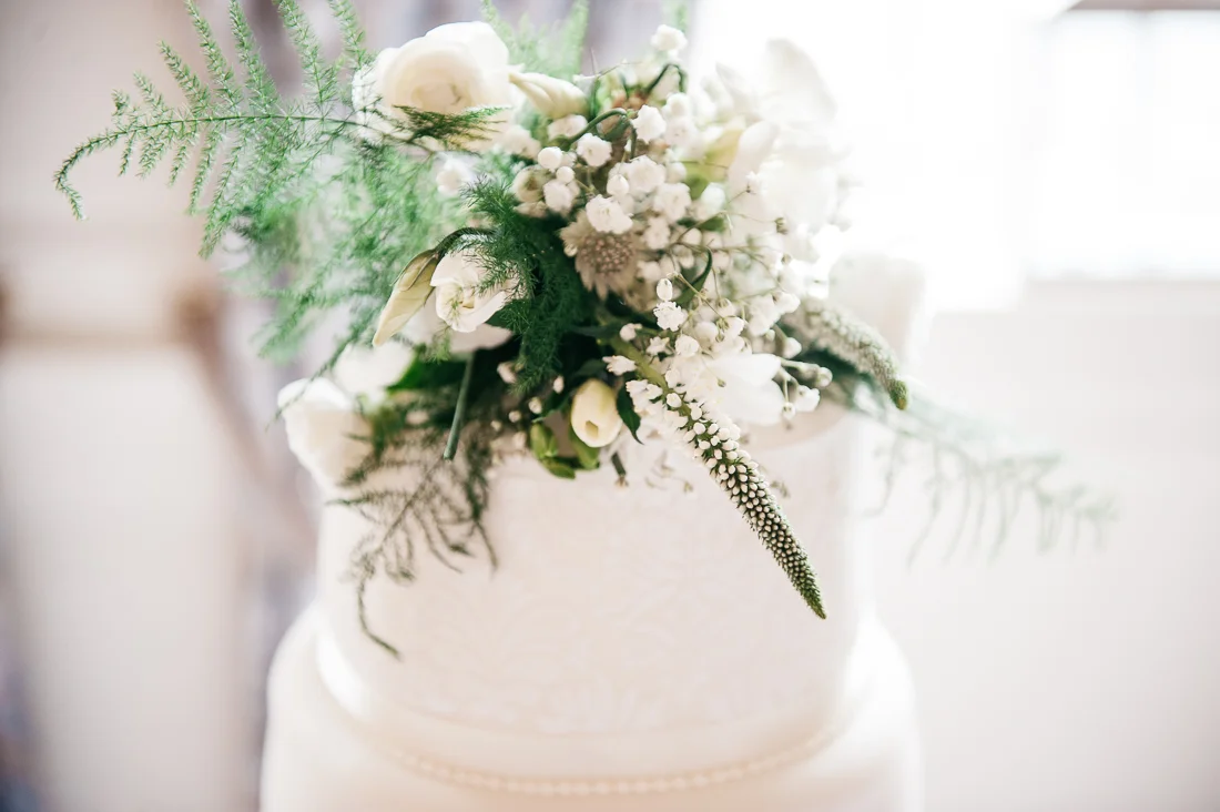 Wedding cake decorated with wild flowers. Lancashire wedding photography