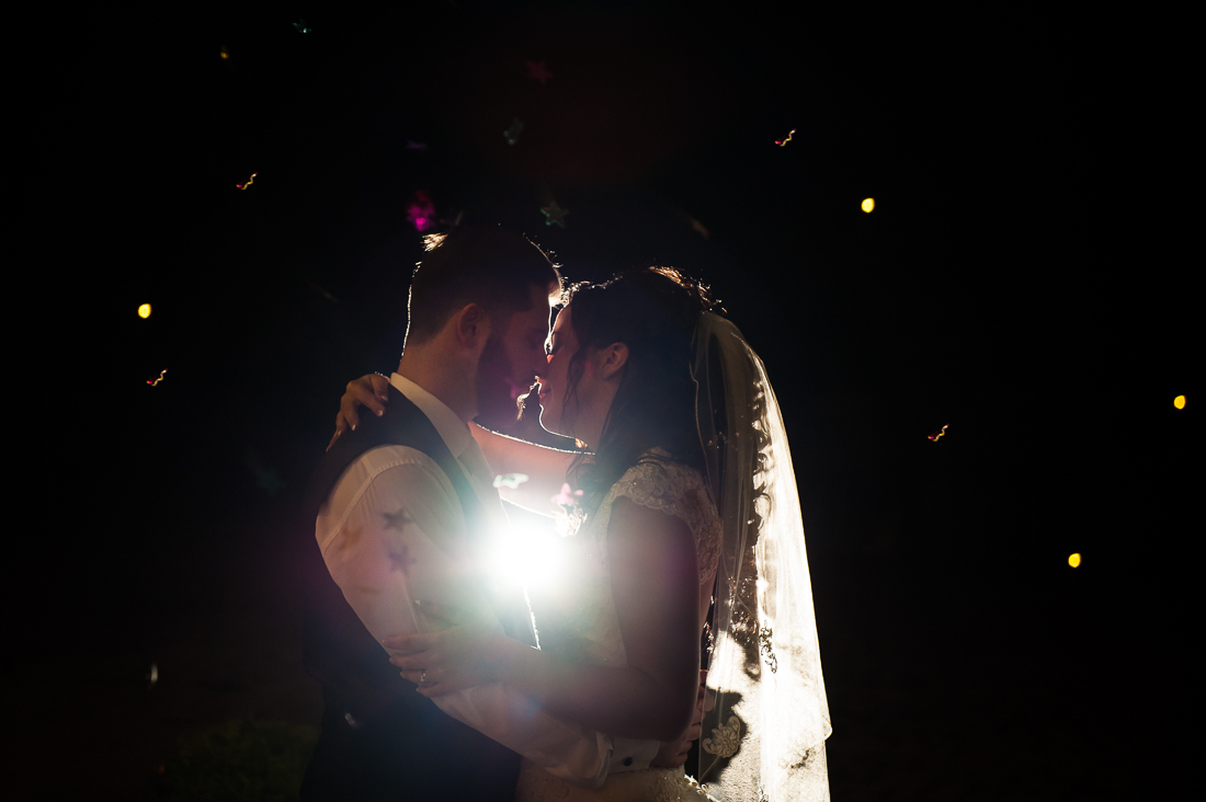 Night time confetti shot with bride and groom