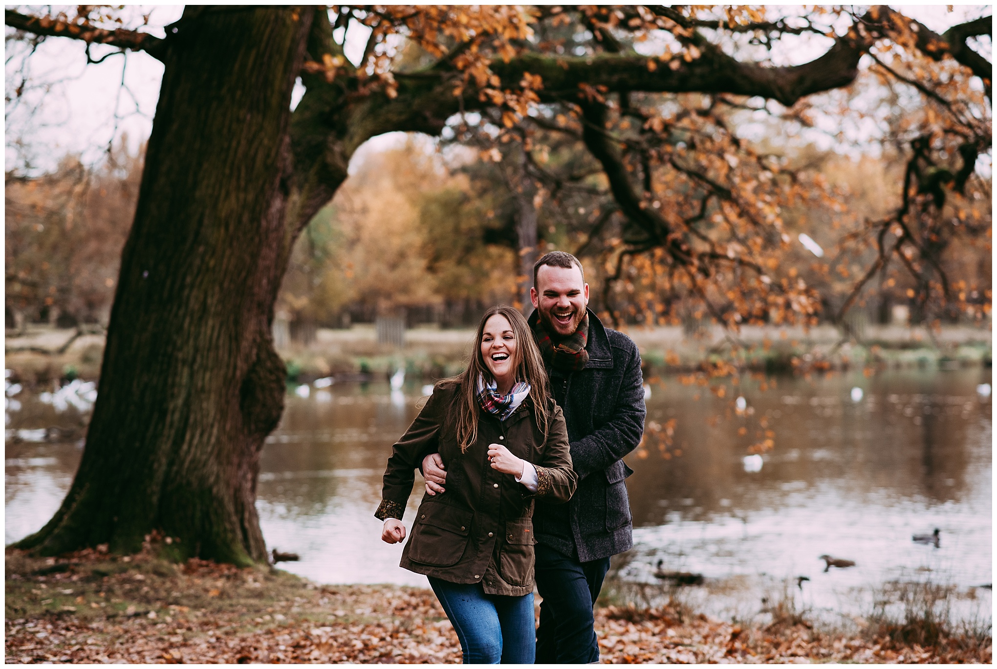 Natural photograph of couple running through woods at Dunham Massey, Altrincham