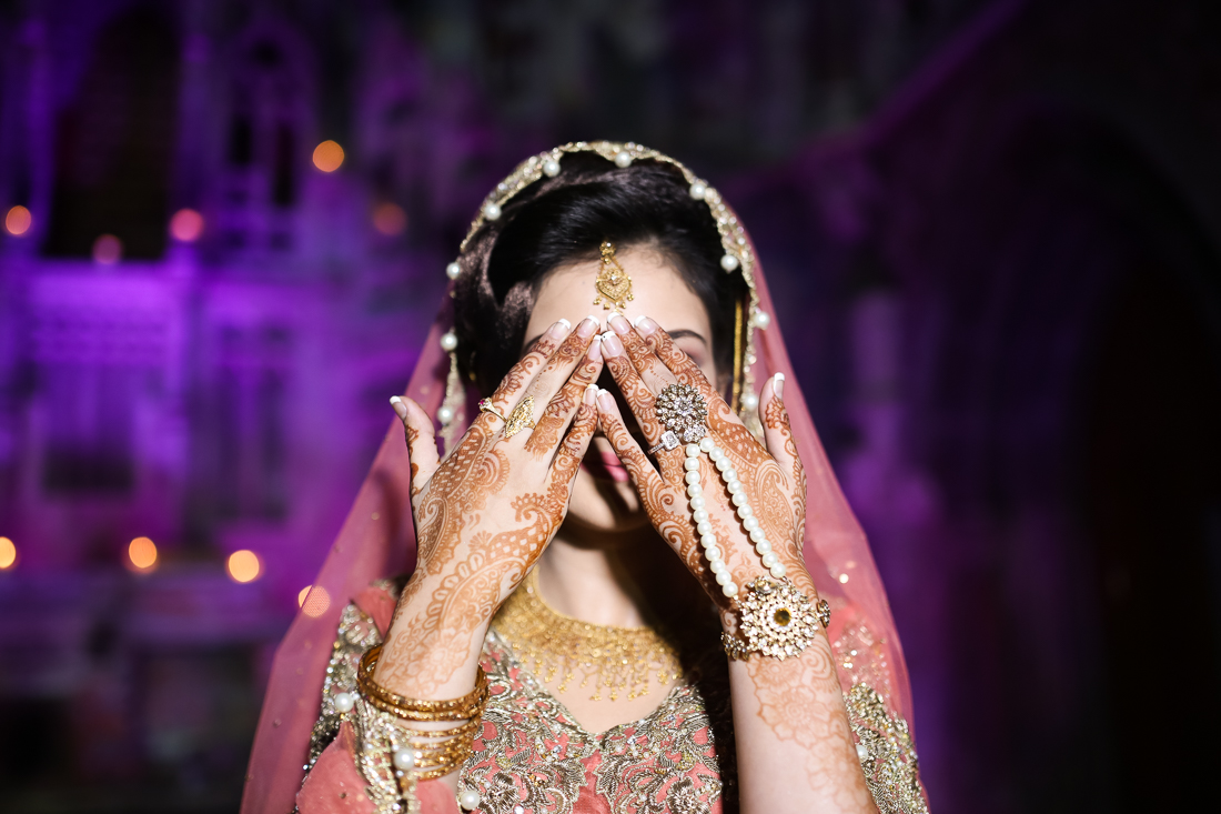 Asian bride holding her hands up to show henna. Manchester Monastery wedding photography