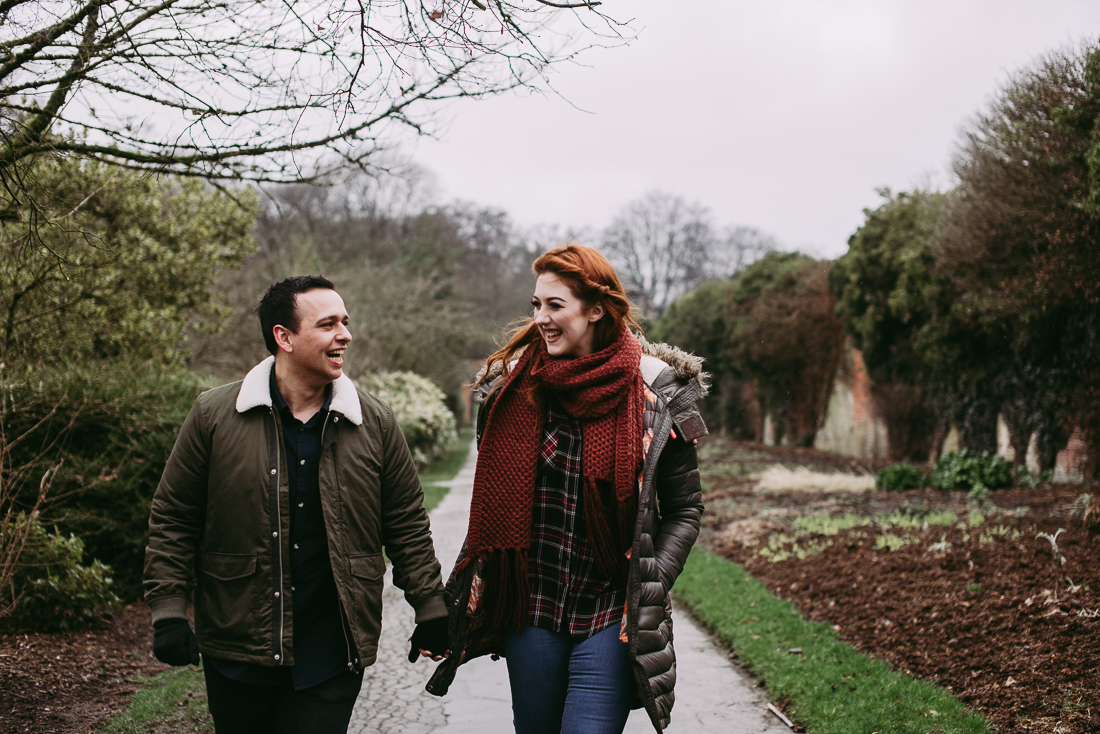 relaxed photography of couple walking hand in hand