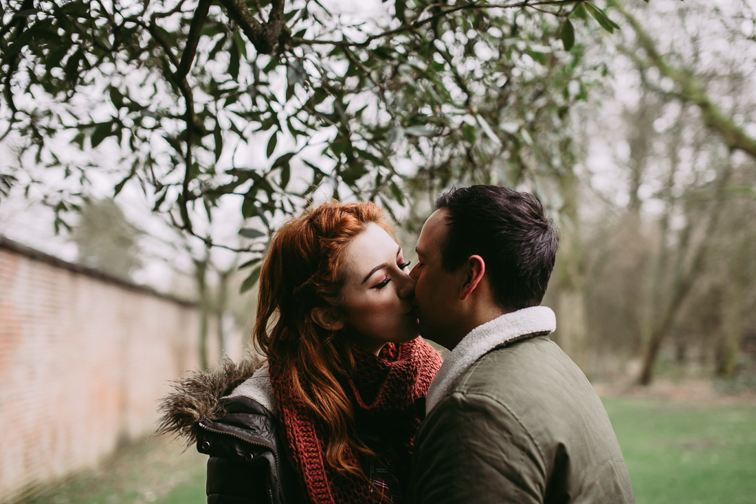 Natural photograph of couple kissing under a tree at Haigh Hall 