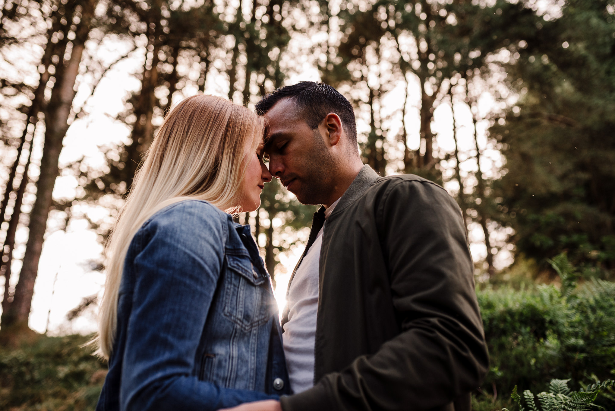 Kissing at sunset in the woods.