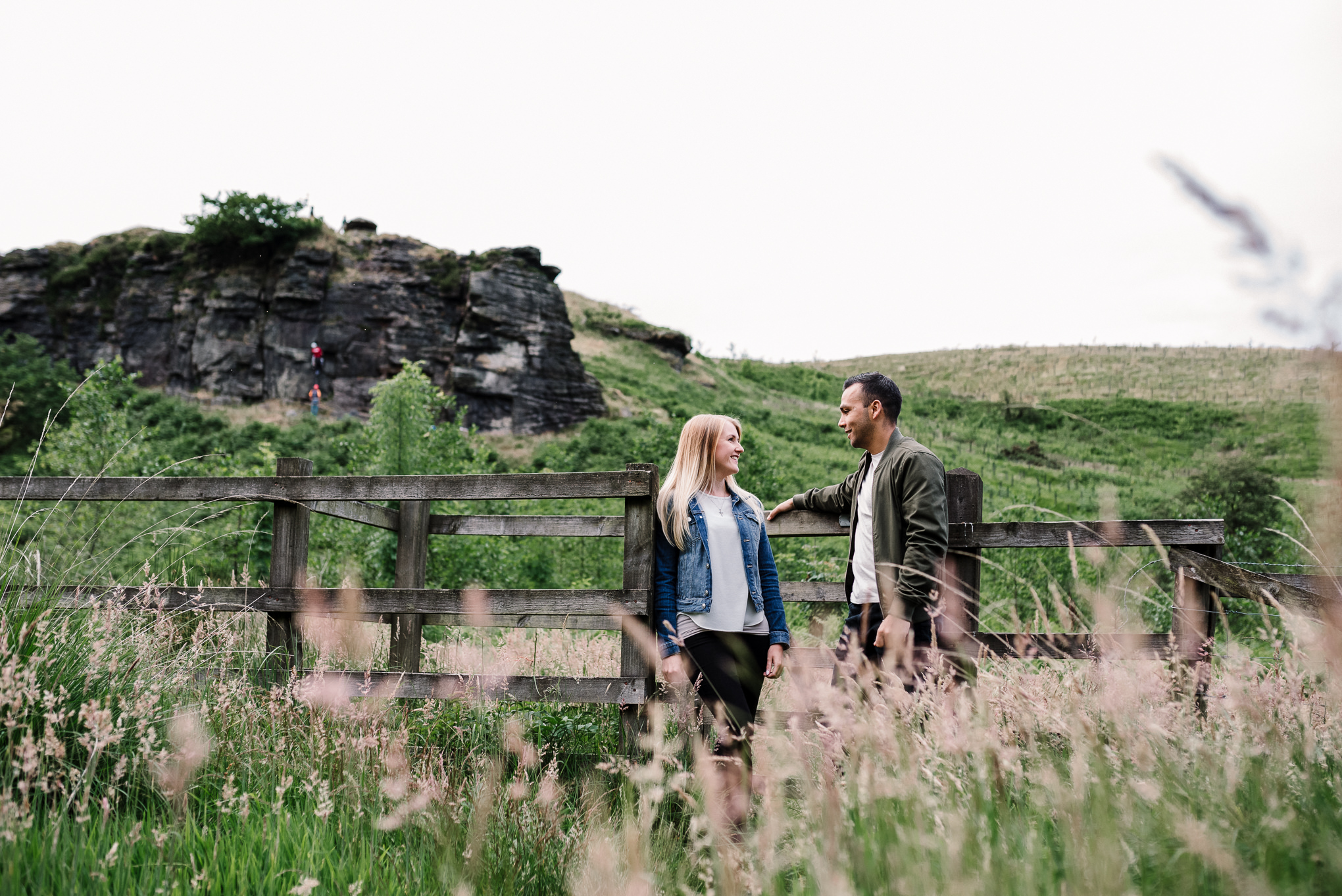 Landscape photo with couple stood naturally at a gate.