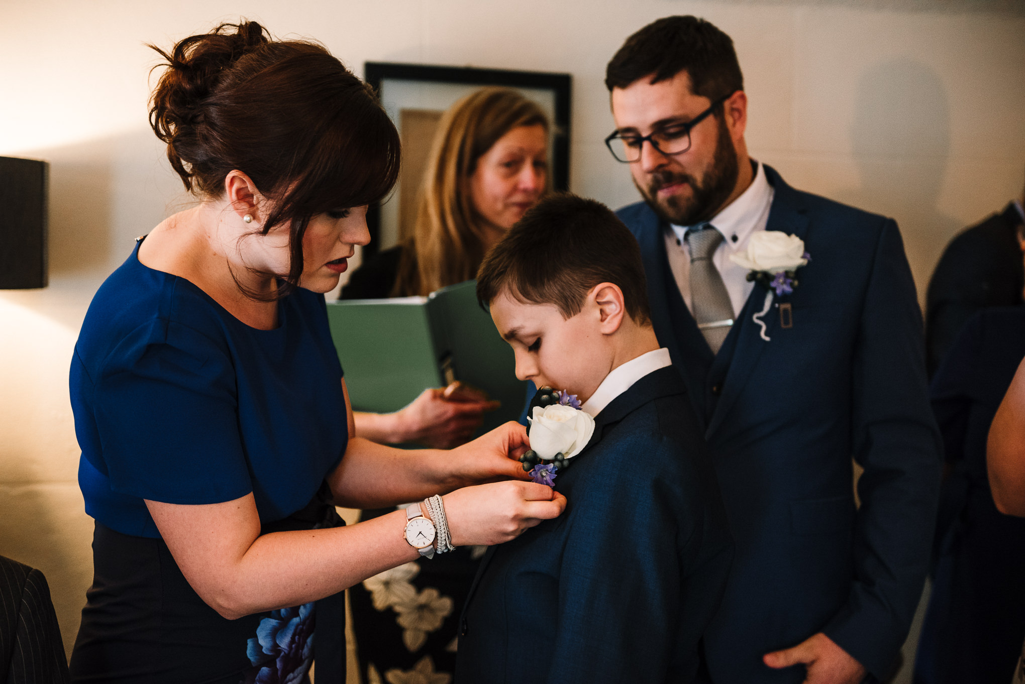 Pageboy having his button hole put on.