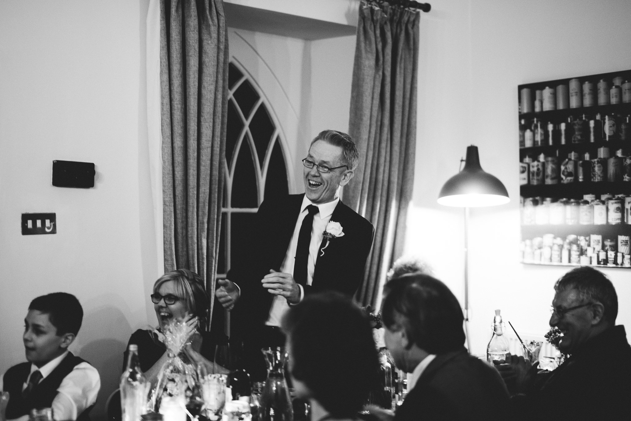 Father of the bride cheering during speeches. Natural photograph.