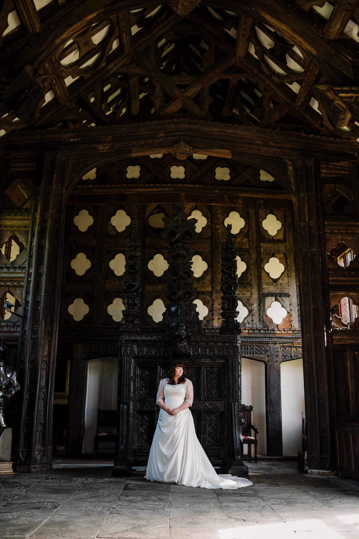 Bride in front of carved oak screen at Rufford Old Hall.