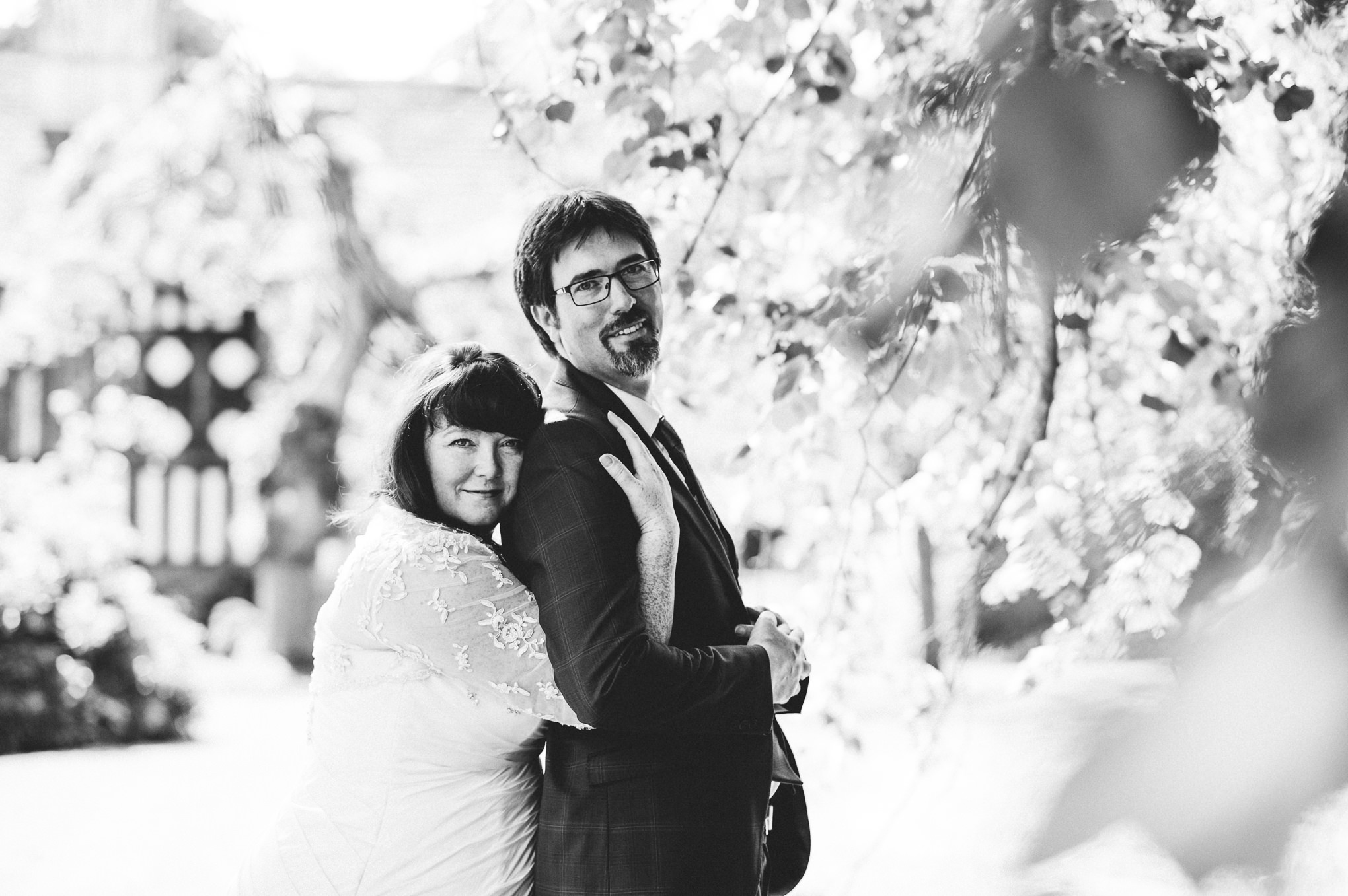 Black and white photograph of bride and groom hugging.