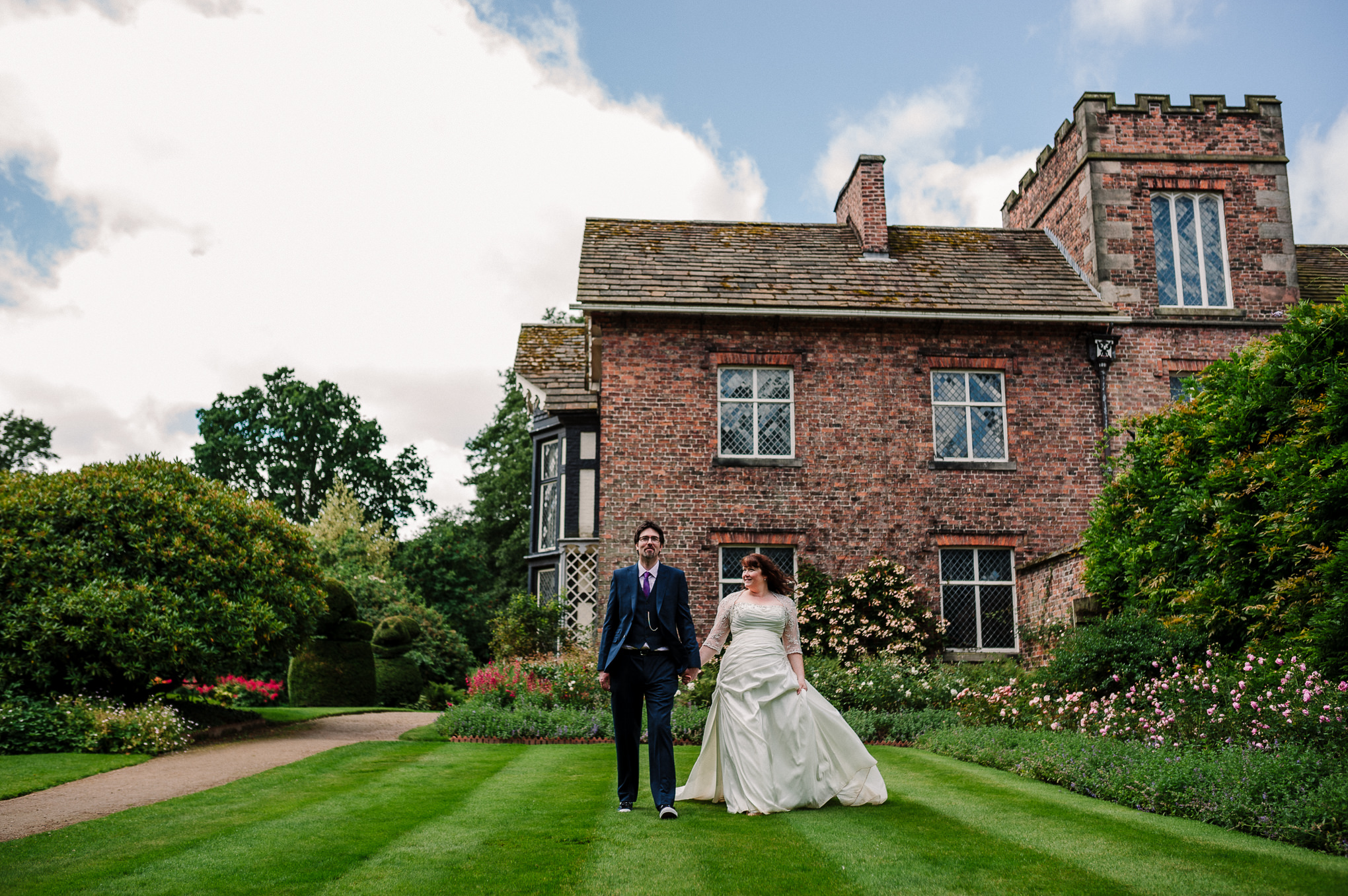 Bride and groom with Rufford Old Hall in the background. Natural wedding photography.