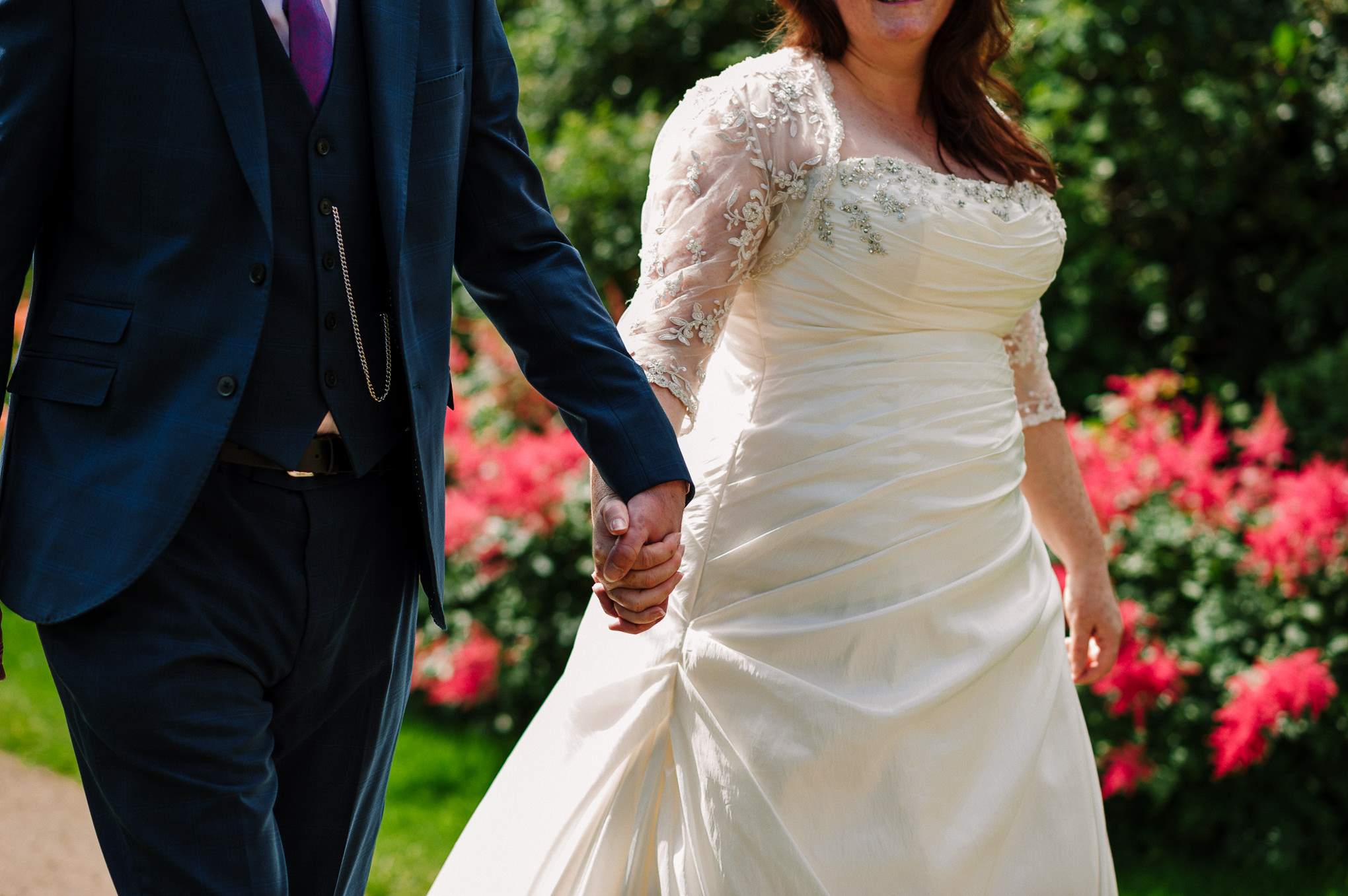 Detailed shot of coupe holding hands.