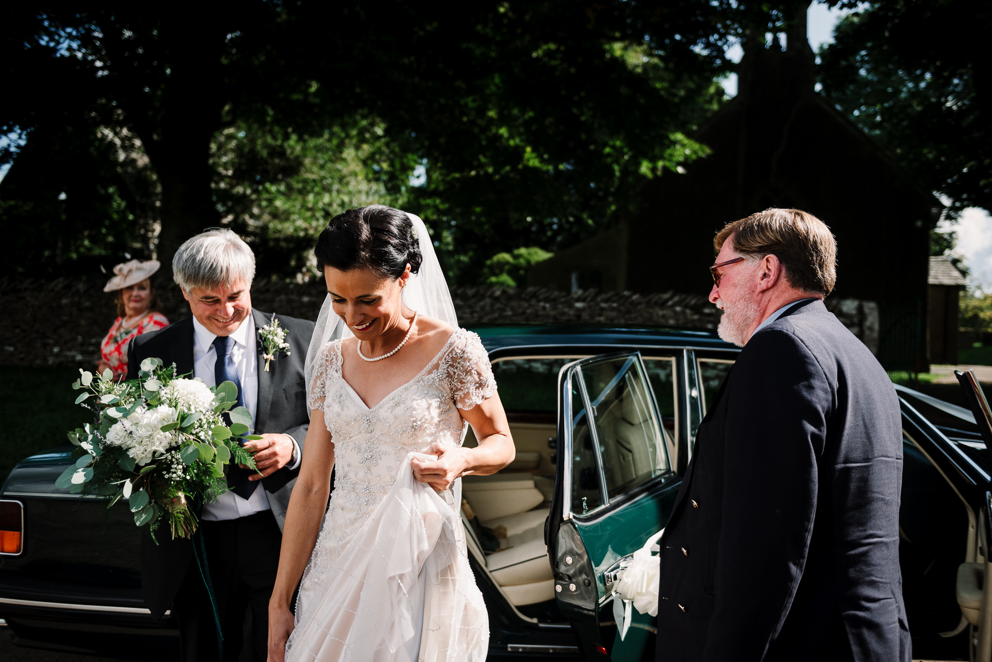 Documentary shot of the bride getting out of the car at church. 