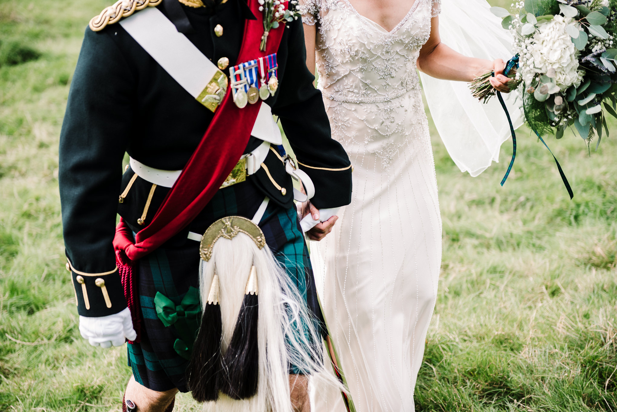 Close up photo of grooms military uniform. 