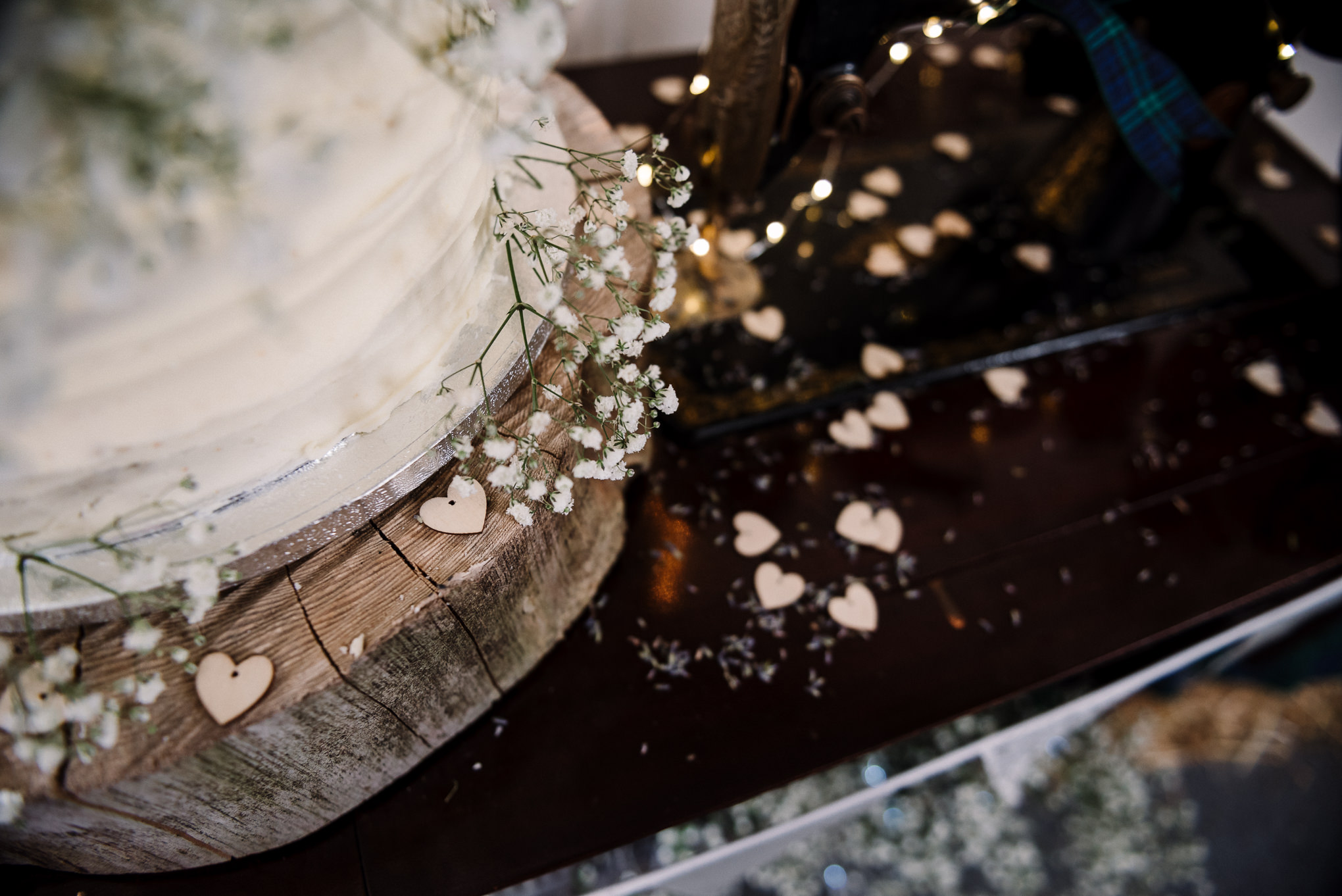 Close up photo of rustic wedding cake and gypsophila 