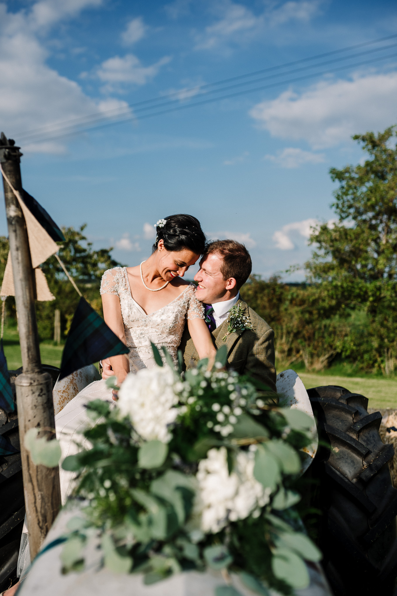 Portrait on the tractor. Farm wedding photography