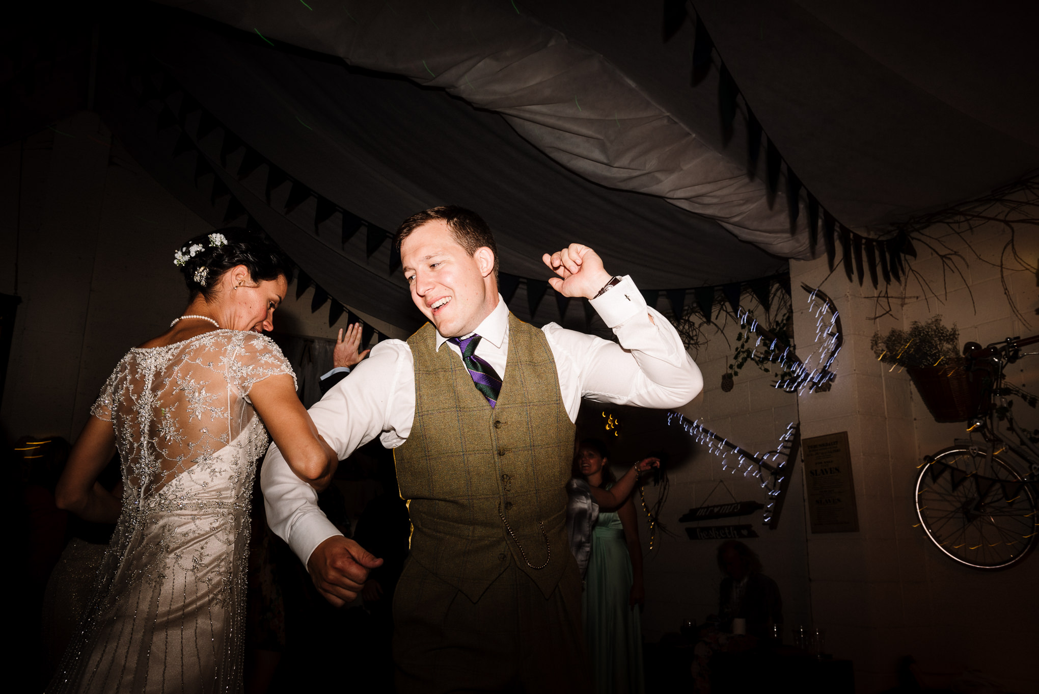 Bride and groom dancing to Ceilidh. Farm wedding photography