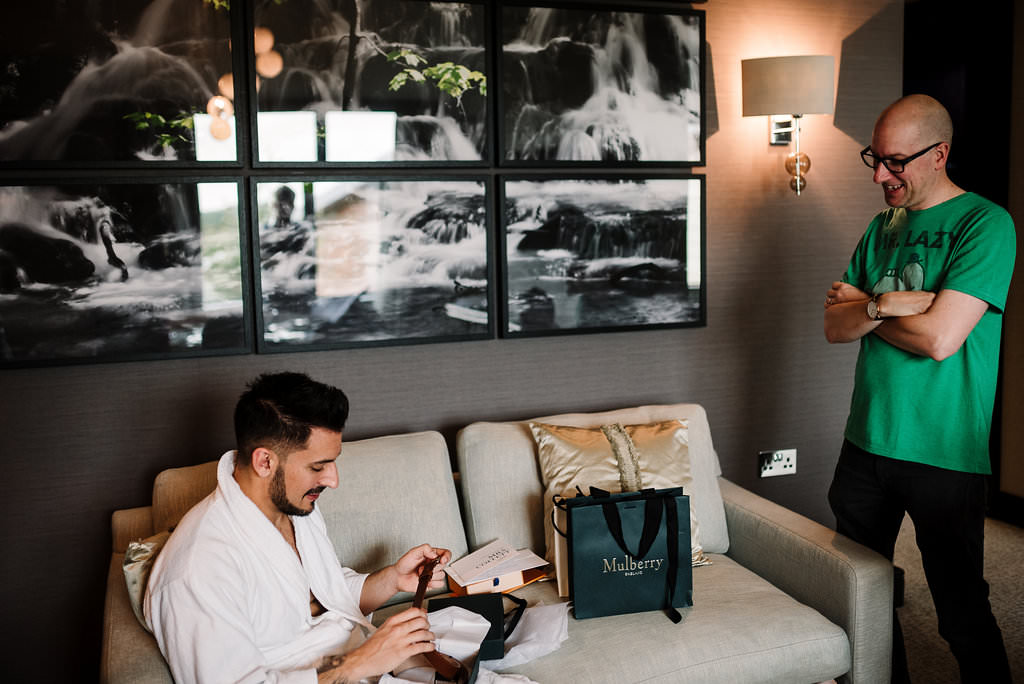 The groom opening his gift on morning of the wedding