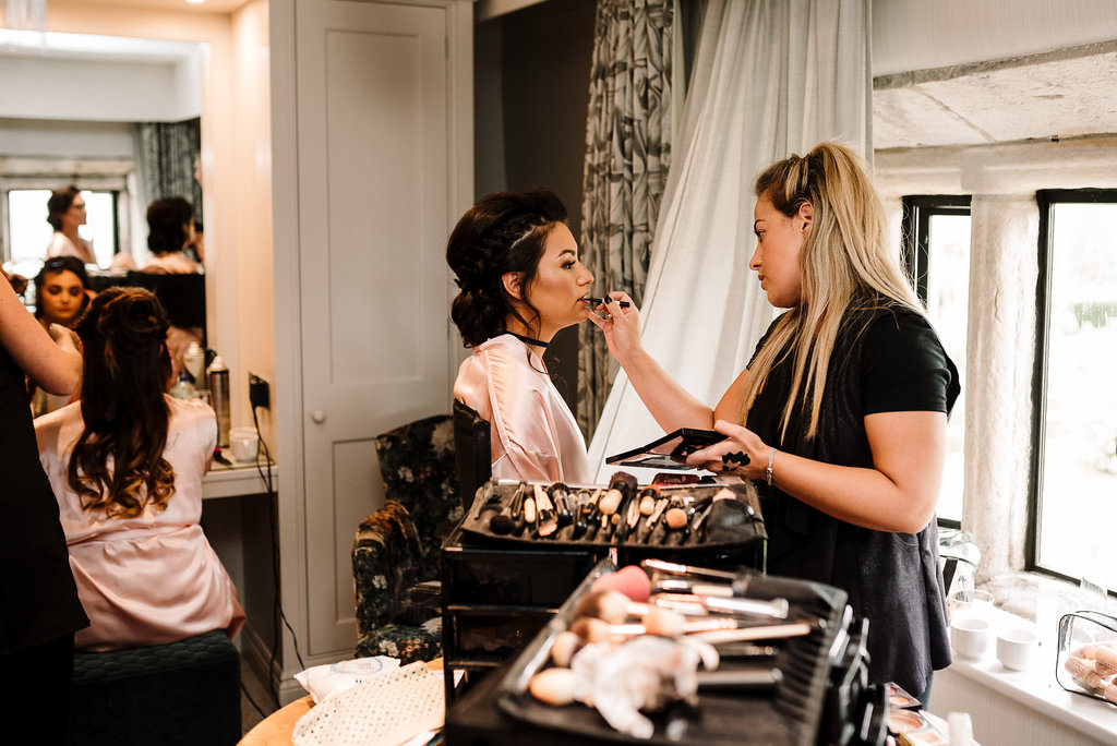 bridesmaid having her makeup applied