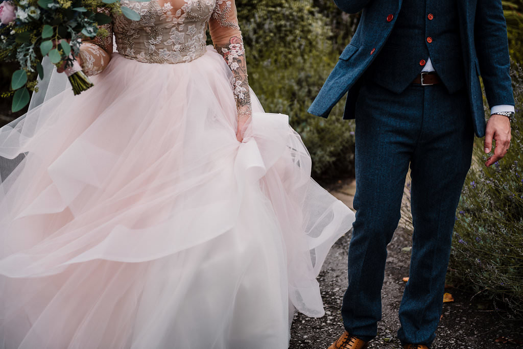 detailed shot of wedding dress and suit