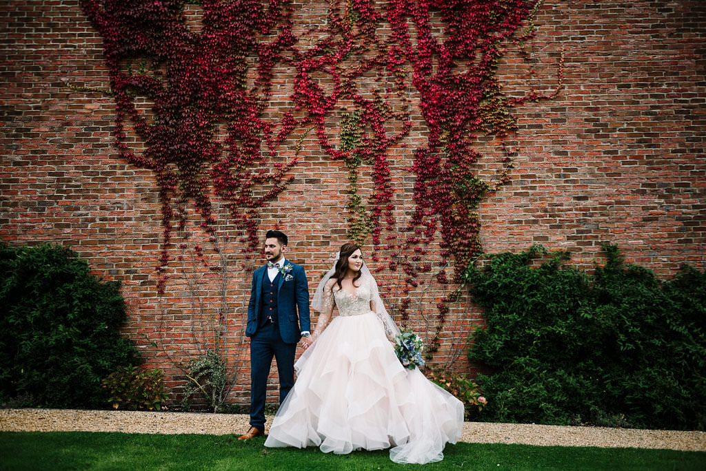 stylish portrait of bride and groom standing together 