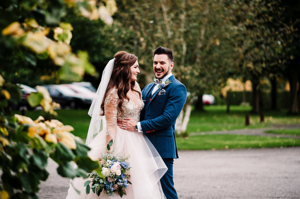 Natural shot of bride and groom laughing together