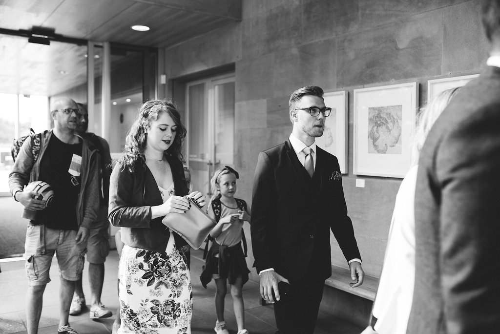 Black and white photo of guests arriving 