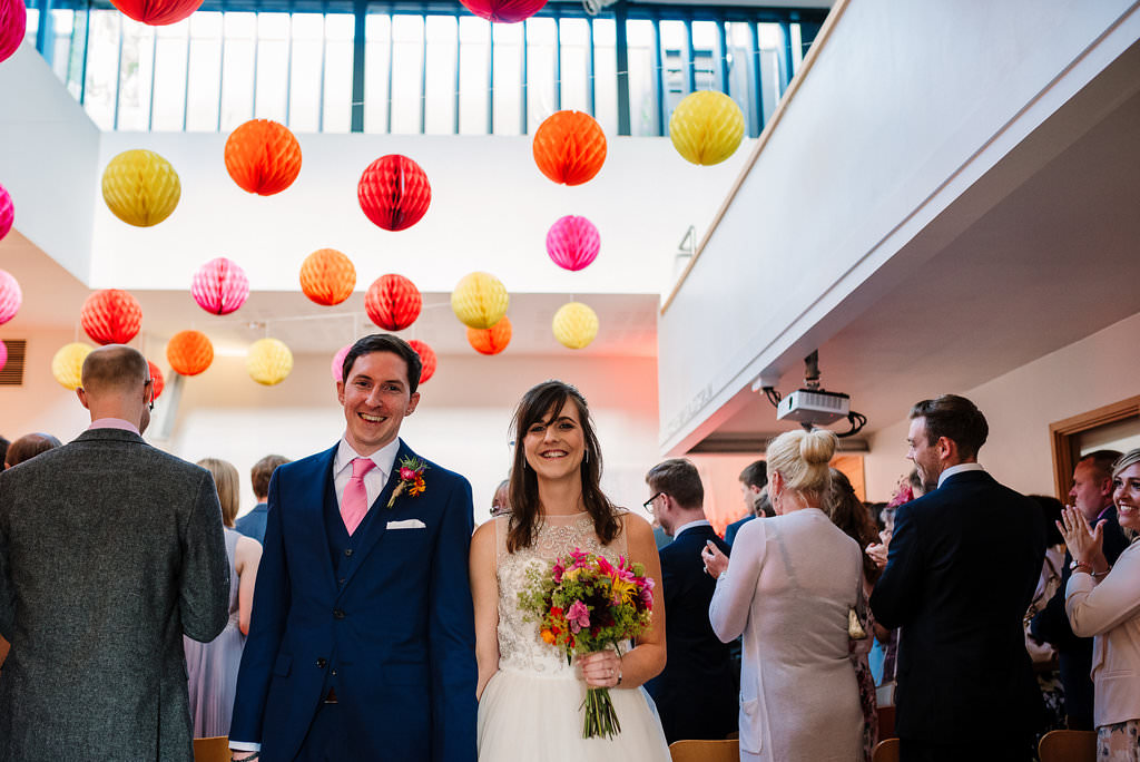 Yorkshire Sculpture Wedding Photographer. Bride and groom walking down the isle. 