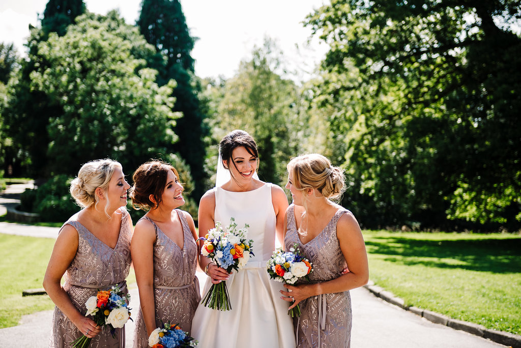 Bride with bridesmaids at Rivington Hall Barn wedding in Bolton, Lancashire. 