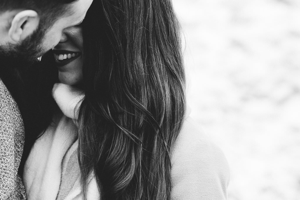 Intimate black and white portrait of couple kissing