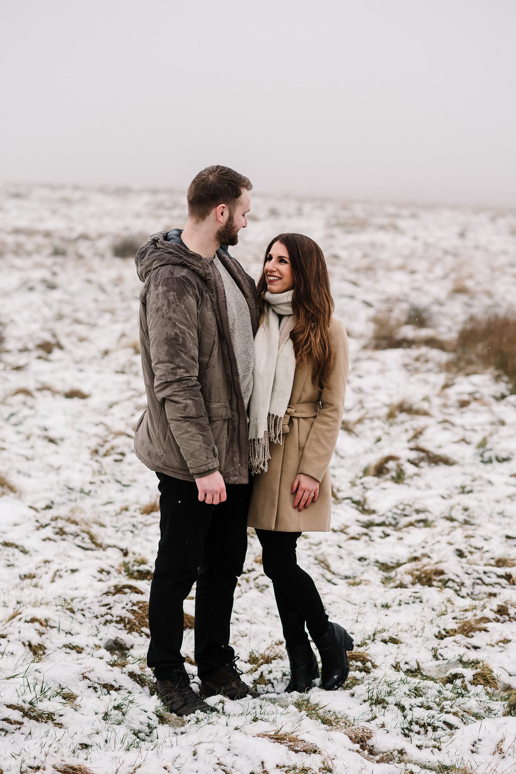 Relaxed shot of couple standing together in the snow