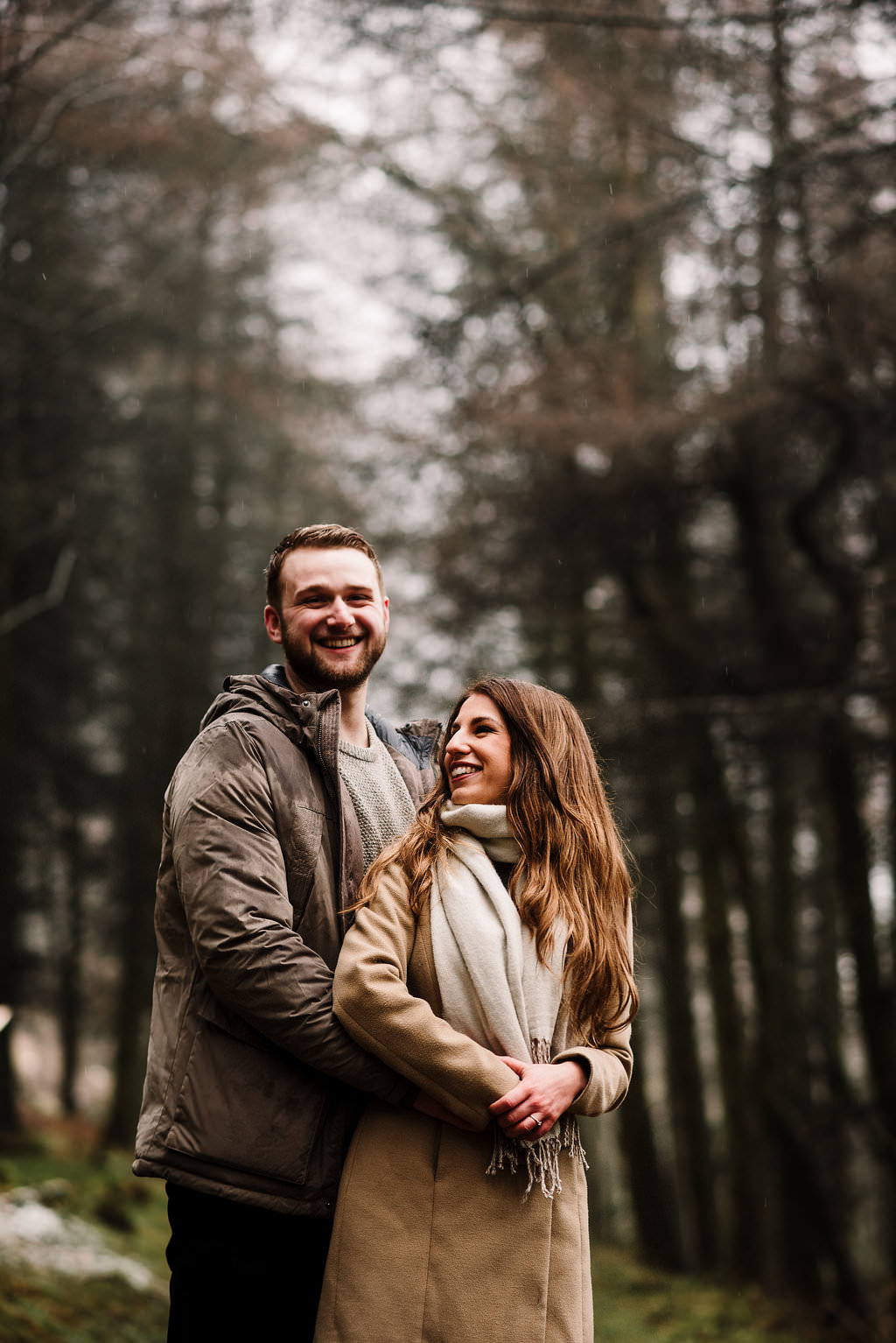 Natural portrait of couple together in the woods laughing. Engagement photography Bolton, Lancashire. 