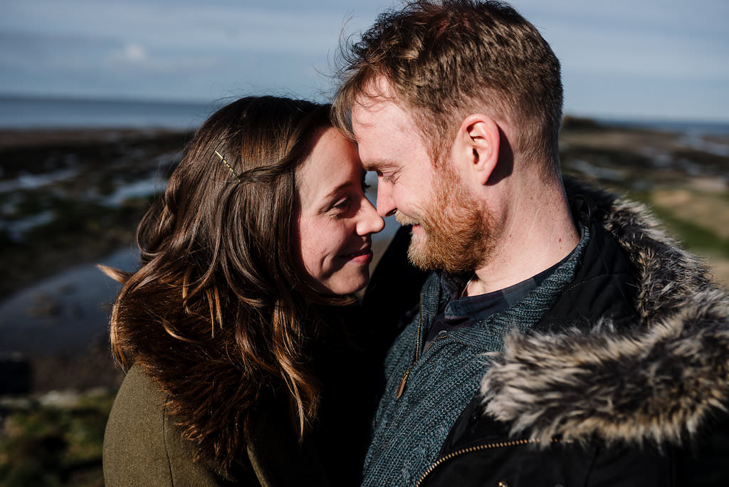 Intimate portrait with views out to sea. West Kirby engagement photography